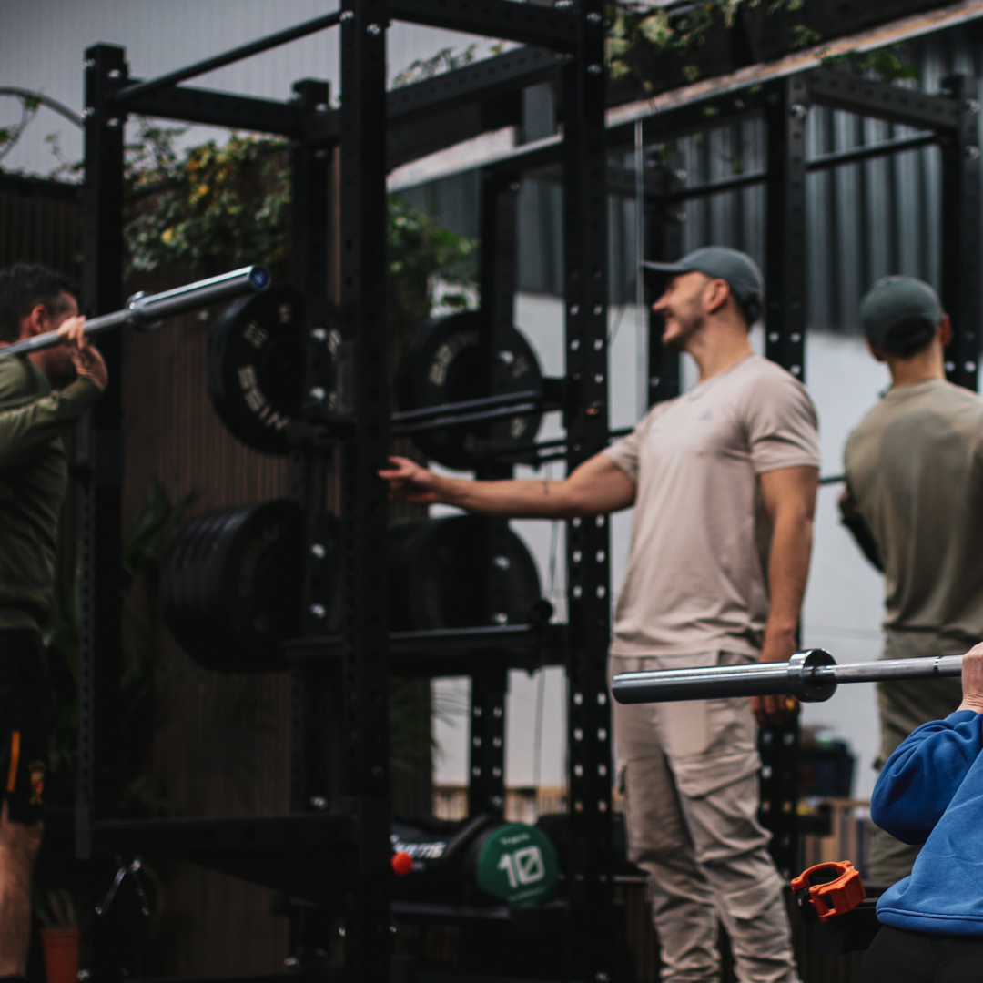 Coaches working with clients on the strength floor at Proteus in Bathford