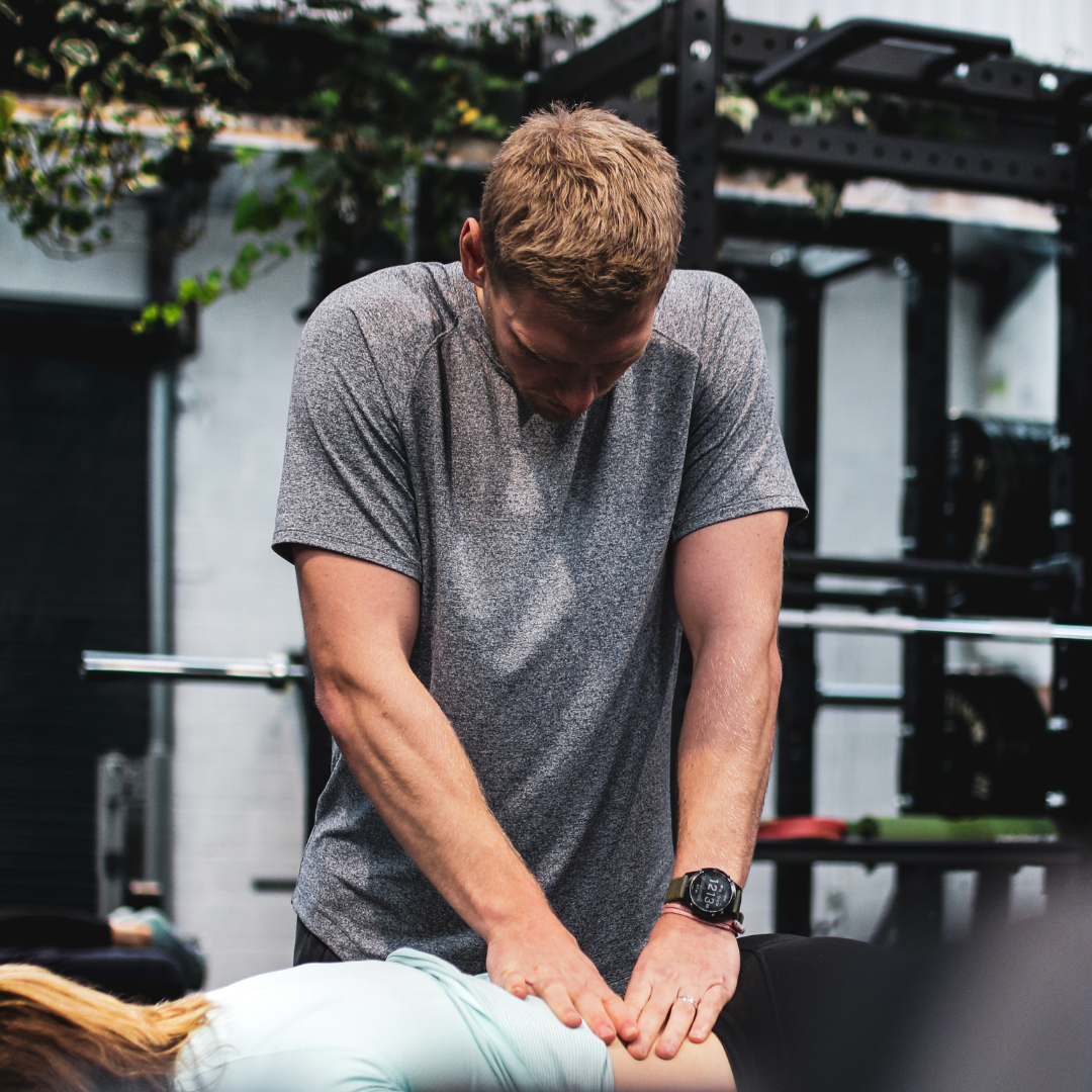 Physiotherapist assessing a client on the treatment table at Proteus